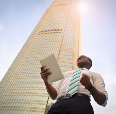 A man in a suit and tie holding a tablet