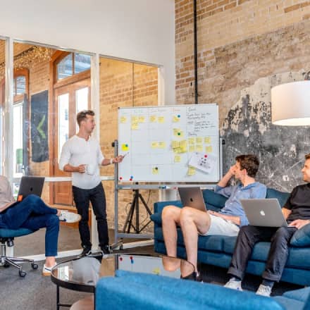 A group of people sitting around in an office.