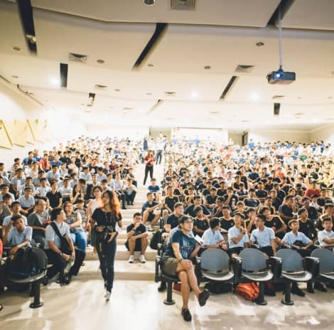 A large group of people sitting in front of a crowd.