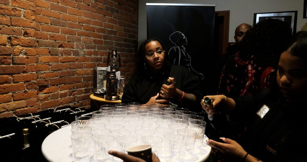 A group of people sitting at a table with cups.